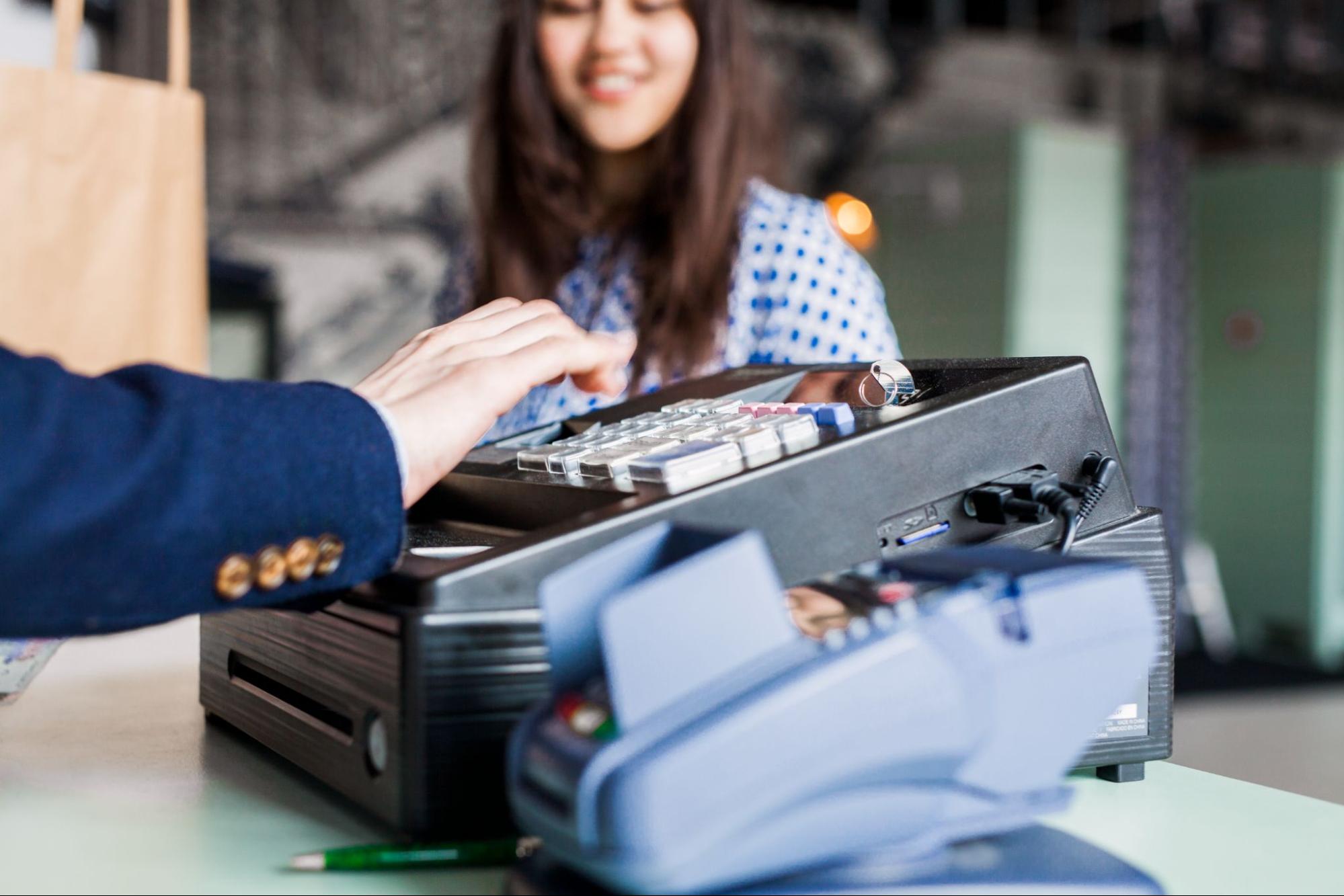 A Person Pressing Buttons On A Cash Register With A Payment Terminal | Condor PH