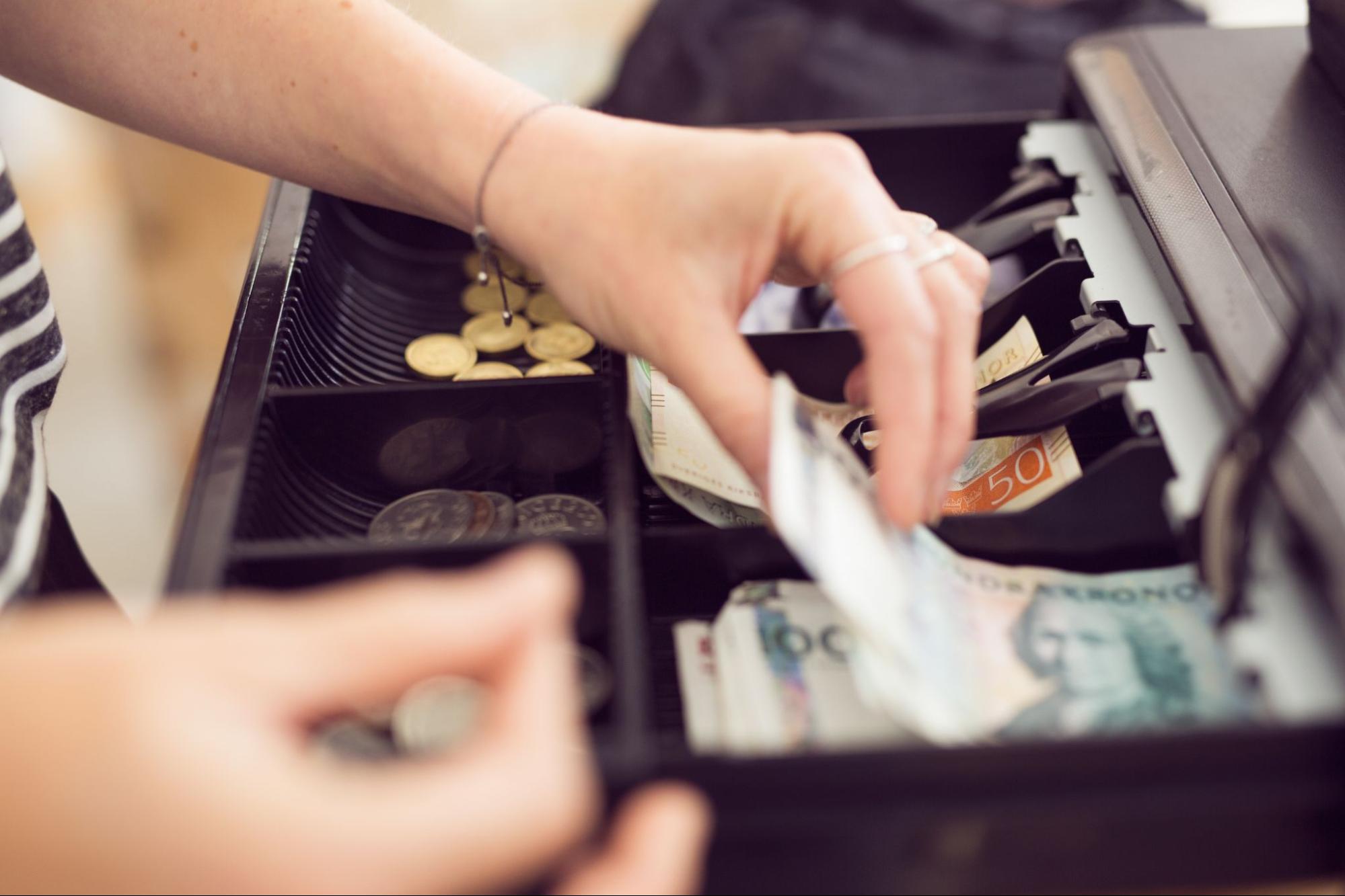 Woman Operating The Cash Register | Condor POS