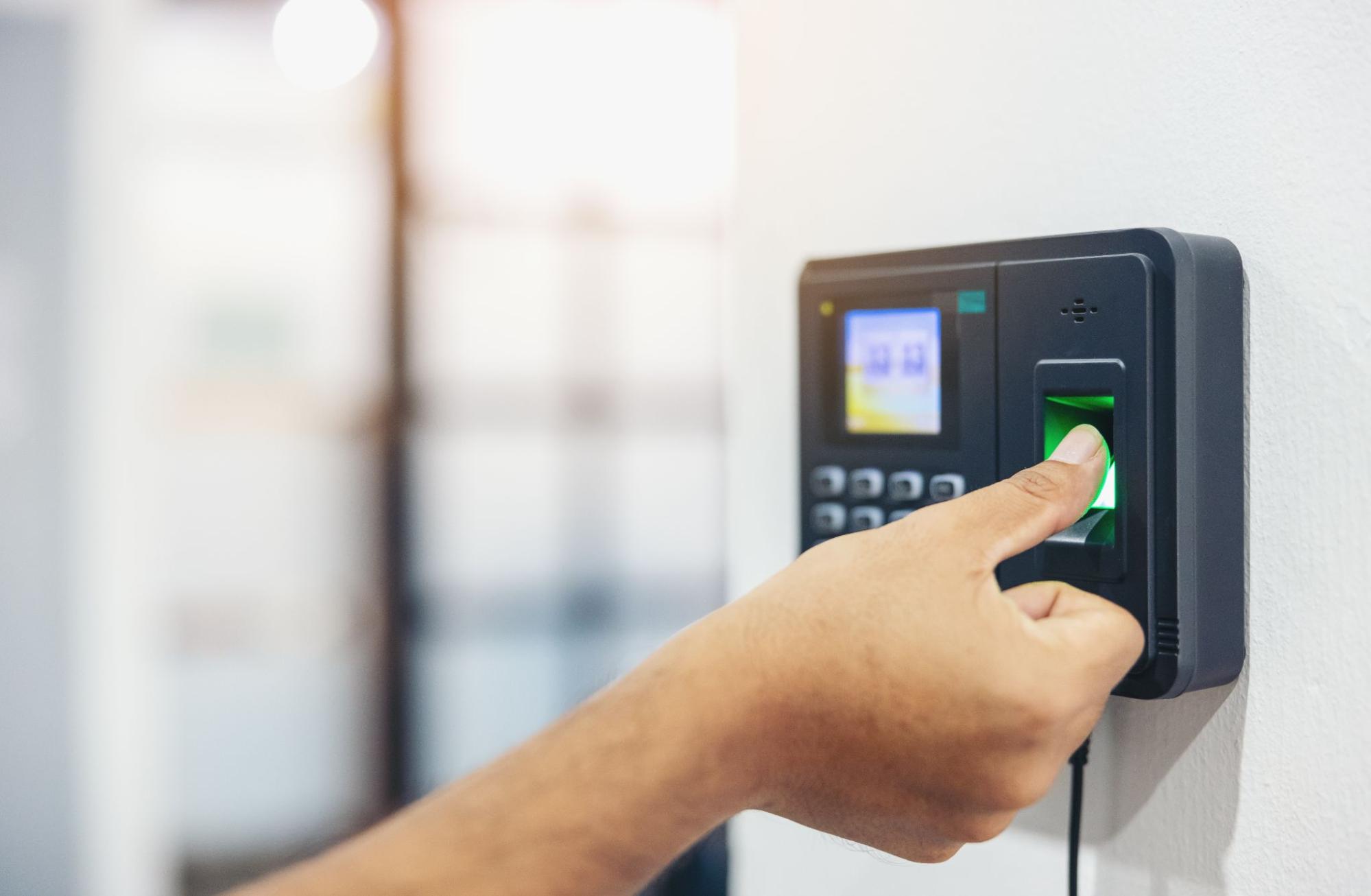 Employee Pressing A Biometric Attendance Machine | Condor PH