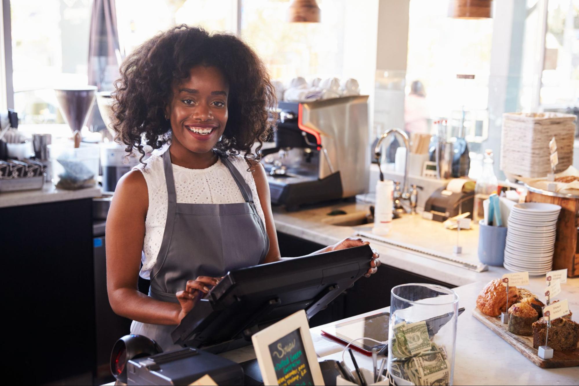 Female Employee Holding The POS | Condor POS